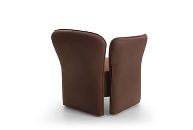 A contemporary upholstered armchair featuring a rounded backrest and integrated armrests that flow down to form the base. The chair is predominantly covered in a textured brown fabric, likely a tweed or boucle. The outer panels of the armrests, from the top down to the floor, are finished in a smoother, slightly darker brown material, possibly faux leather or a contrasting plain fabric, creating a subtle two-tone effect. The design emphasizes comfort with its soft curves and plush appearance, without visible legs. — 3D model