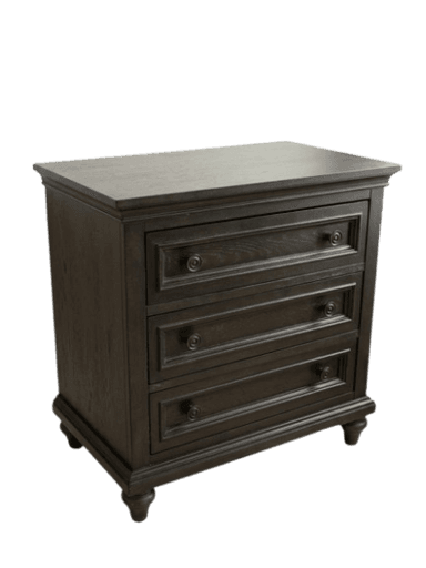 A traditional dark brown nightstand featuring three drawers with paneled fronts and ornate circular pulls, standing on four short, turned bun feet, with a classic molded top edge. — 3D model