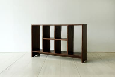 A dark brown wooden shelving unit with multiple open compartments, featuring a solid construction and varying shelf configurations. — 3D model