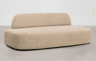 An elongated, contemporary upholstered sofa featuring a distinctive low, curved backrest. The entire piece is covered in a light beige or sand-colored fabric, presenting a soft and monolithic form with rounded edges. — 3D model