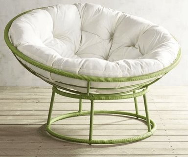 A contemporary papasan-style lounge chair featuring a circular green frame and a large, plush, tufted white cushion. The frame appears to be made of metal, possibly wrapped with a green cord or rattan-like material, creating a distinctive texture. The cushion is deeply tufted, providing a comfortable and inviting seating surface. The chair rests on a stable, low-profile base, also constructed from the same green material. — 3D model
