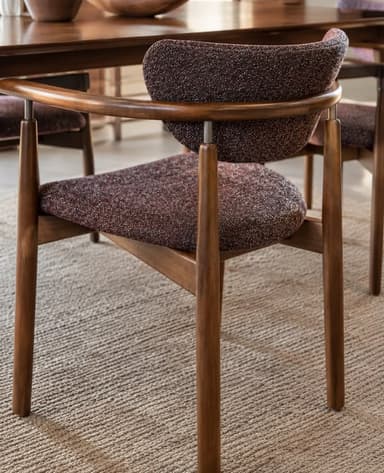 A contemporary dining armchair featuring a dark brown wooden frame, integrated armrests, and speckled brown fabric upholstery on the seat and curved backrest. — 3D model