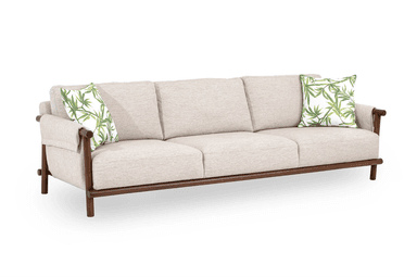A three-seater sofa featuring a light beige fabric upholstery and an exposed dark-stained wooden frame. It includes three seat cushions, three back cushions, and two decorative pillows with a green botanical pattern. — 3D model