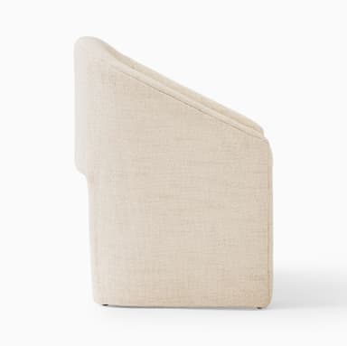 A compact, contemporary barrel-back accent chair, fully upholstered in a light beige or cream textured fabric, featuring a continuous curved backrest that integrates into armrests, and a solid plinth-style base. — 3D model