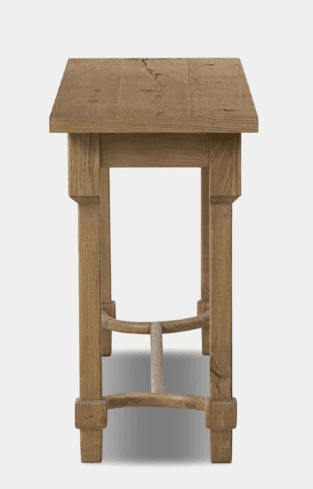 A long, narrow wooden console table with a rectangular top surface. It features four straight, block-style legs connected by a horizontal stretcher bar along the bottom. Distinctive curved, semi-circular wooden supports are integrated into the stretcher bar near the base of each leg. The wood exhibits a light, natural, or distressed finish. — 3D model