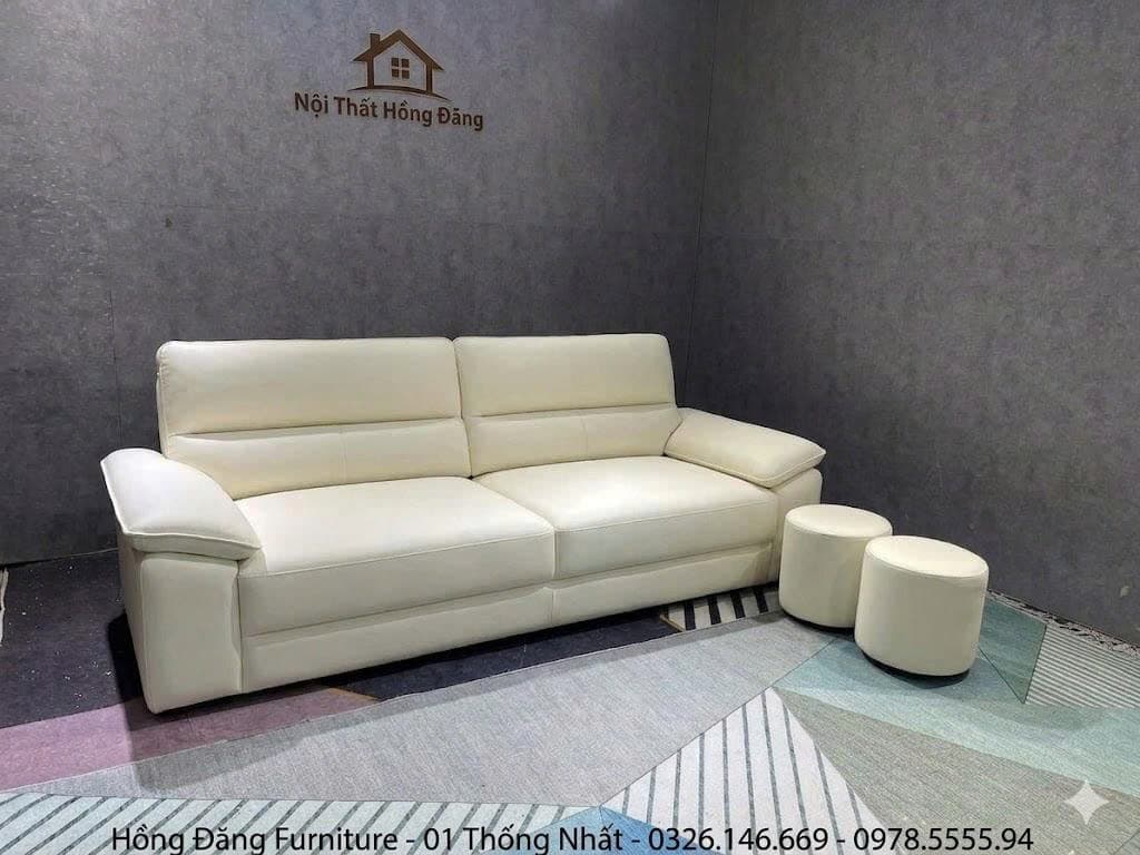 This is a modern two-seater sofa upholstered in cream-colored leather, featuring clean lines and a minimalist design. It has two distinct seat cushions and two backrests, each with an integrated adjustable headrest for personalized comfort. The arms are wide and flat, adding to its contemporary profile. The sofa sits on low-profile, dark block feet, giving it a sturdy and grounded appearance. — 3D model