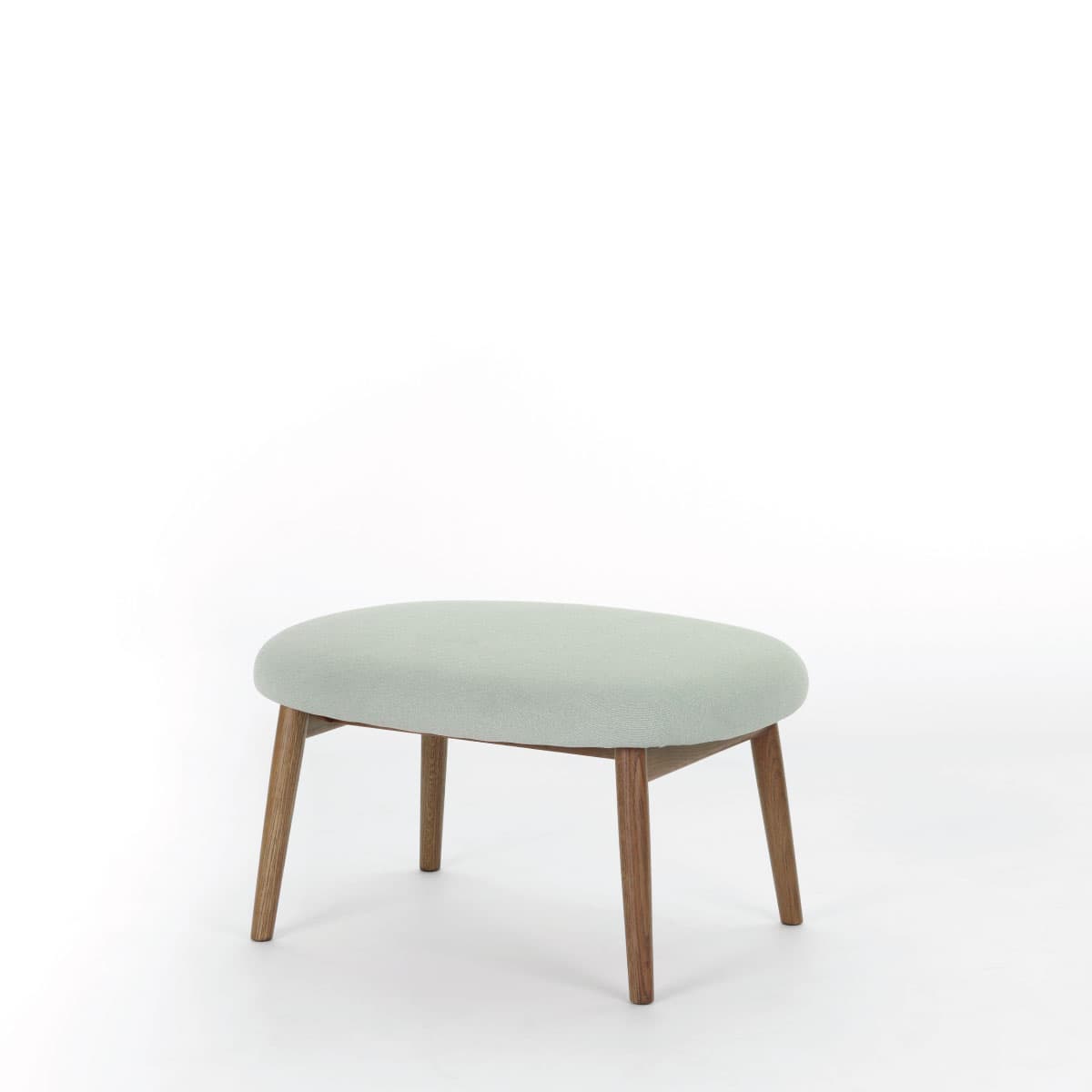 A minimalist oval-shaped ottoman featuring a light green upholstered top and four slender, tapered wooden legs. The design is simple and clean, suggesting a contemporary aesthetic. The fabric has a subtle texture, and the wood grain is visible on the legs. — 3D model