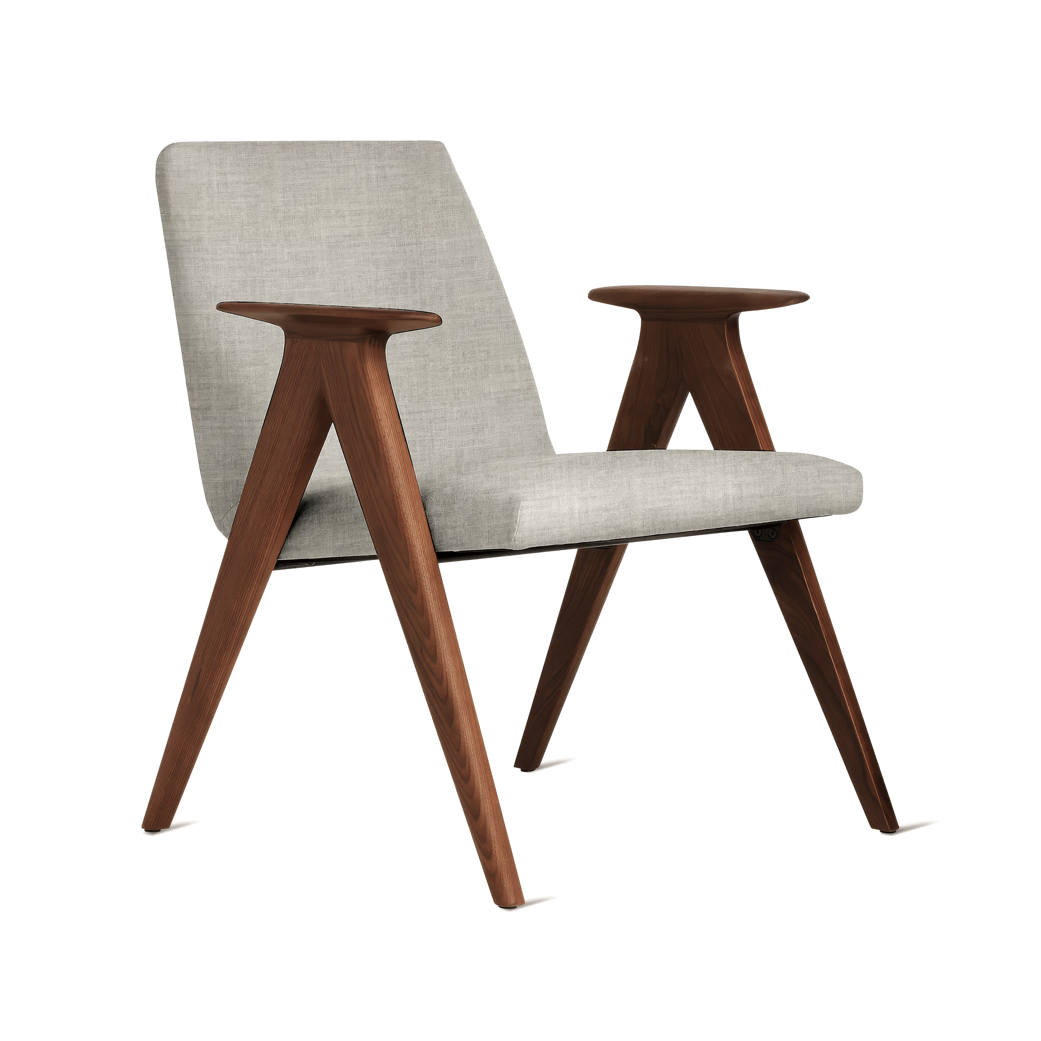 A modern armchair featuring a sleek design with a visible wooden frame and upholstered seating. The frame is crafted from a dark-toned wood, likely walnut, forming distinctive sculptural armrests and tapered, angled legs. The seat and backrest are upholstered in a light grey or beige fabric with a textured weave. — 3D model