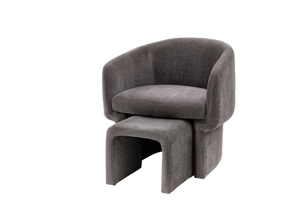 A modern upholstered armchair with a matching ottoman. The armchair features a rounded back and arms that extend forward, enclosing the seat. The seat and back are unified by soft upholstery. The ottoman has a sleek, open base with a curved U-shape. — 3D model