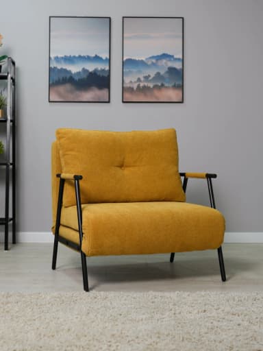 A modern upholstered armchair featuring a bright yellow fabric and a minimalist black metal frame. The chair has a comfortable, button-tufted back cushion and a thick, layered seat cushion. The metal frame extends to form slender armrests, partially covered with a lighter-colored wrap. The design incorporates a mechanism that suggests it may be convertible, possibly into a bed, given the layered structure beneath the seat. Its overall aesthetic is contemporary and functional. — 3D model