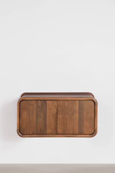 A wall-mounted cabinet made of dark wood, featuring a rectangular form with smoothly rounded edges on all sides. It has two vertical doors on the front that are flush with the frame, showcasing a natural wood grain. The cabinet appears to float, being securely affixed to a light-colored wall. — 3D model