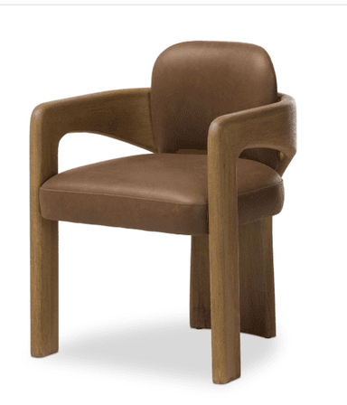 A contemporary armchair featuring a solid wood frame, likely oak, with a light brown finish and visible grain. The design includes a deeply curved backrest that gracefully extends to form integrated armrests. A plush brown leather or faux leather upholstery is visible on the seat and inner backrest, providing a contrast to the natural wood. The chair's legs are sturdy and straight, complementing the clean lines of the design. The overall aesthetic is modern, sculptural, and organic. — 3D model