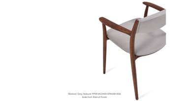A side profile view of a modern armchair with a wooden frame and upholstered seat and backrest. The frame is constructed from solid ash with a walnut finish. The upholstery appears to be a light grey nubuck fabric. — 3D model