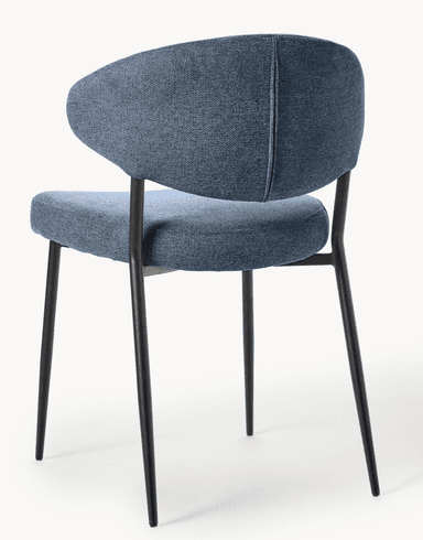 A contemporary dining chair featuring a blue upholstered seat and a distinctively curved, armless backrest. The chair is supported by four slender, tapered black metal legs. — 3D model
