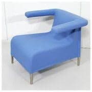 A modern armchair with an asymmetric design. It features a curved seat and back, with one armrest extending outwards and upwards from the main body, while the other side is open. The chair is supported by four slender, cylindrical metal legs. — 3D model
