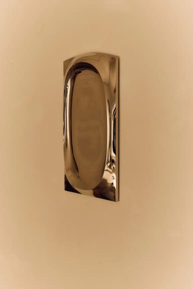 A rectangular wall mirror featuring a deep, organically shaped recessed opening for the reflective surface. The frame appears to be made of a substantial cast metal with a matte gray finish. — 3D model