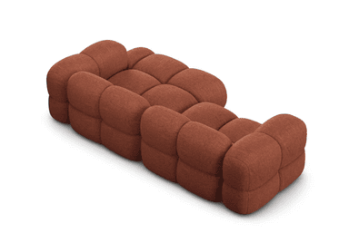 A modular sofa with a rounded, puffy design, featuring distinct individual cushions for the seat and backrest. The sofa appears to be upholstered in a textured fabric and is configured in an L-shape, with an armrest on the left side. — 3D model