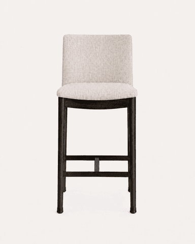 A contemporary bar stool featuring an upholstered seat and backrest set on a dark wooden frame with integrated footrests. — 3D model