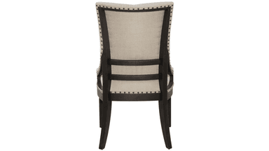 A high-backed armchair with tufted upholstery and nailhead trim. The frame appears to be dark wood, contrasting with the light-colored fabric. — 3D model