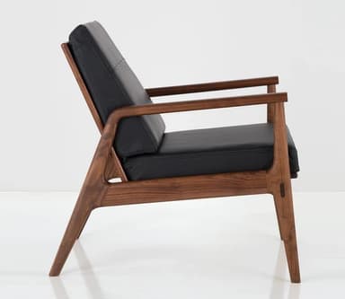 A two-view technical drawing of a modern lounge chair, featuring a sturdy wooden frame, padded seat and back cushions, and integrated armrests. The diagram includes precise dimensions for height, width, and depth. — 3D model