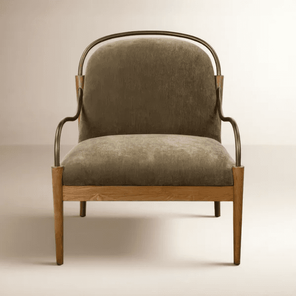 A contemporary upholstered accent armchair featuring a light oak wooden frame and distinctive curved metal arms in a bronze or brass finish. The seat and backrest are generously cushioned and upholstered in an olive green or khaki fabric. The chair stands on four tapered wooden legs, and the overall design is clean and modern. — 3D model