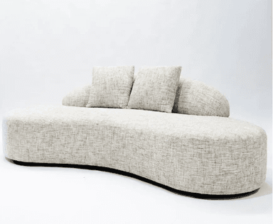 A modern, upholstered sofa with a distinctive curved silhouette. It features a low profile and a flowing, organic shape. The sofa is covered in a textured, neutral-toned fabric and includes two matching throw pillows. The base appears to be dark and slightly recessed. — 3D model