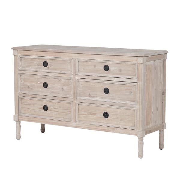 A rectangular dresser constructed from light-colored, whitewashed wood with a distressed finish. It features six drawers arranged in two columns of three, each with a recessed panel and a single round black knob. The dresser is supported by four turned legs. — 3D model