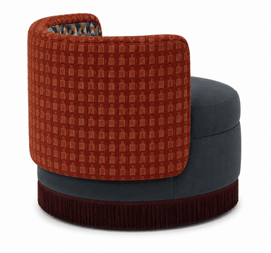 An upholstered barrel-back accent chair featuring a circular seat and a low, continuous back and armrest structure. The seat and the lower body are upholstered in a solid dark grey fabric. The exterior of the back and arms is covered in a reddish-brown textured fabric, while the interior back showcases a multi-colored geometric pattern. A decorative fringe in a matching dark reddish-brown hue encircles the base. — 3D model