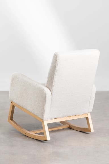 A rocking chair with a plush, textured upholstery and a natural wood frame. The chair features a high back and padded arms. The base consists of curved wooden runners that allow for rocking motion. The upholstery has a boucle-like texture, and the wood appears to be light-toned and smooth. — 3D model