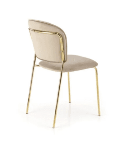 An armless chair featuring a channel-tufted backrest and a padded seat, both upholstered in a light beige velvet-like fabric. The chair stands on four slender, round, gold-toned metal legs. The backrest has a rounded top edge, contributing to a modern and elegant aesthetic. — 3D model