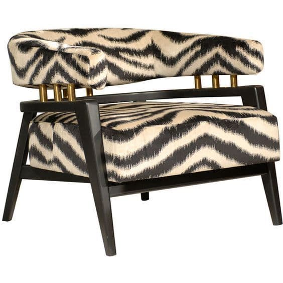 An upholstered accent armchair featuring a black and off-white zig-zag patterned fabric, a dark wooden frame, and brass cylindrical supports. — 3D model