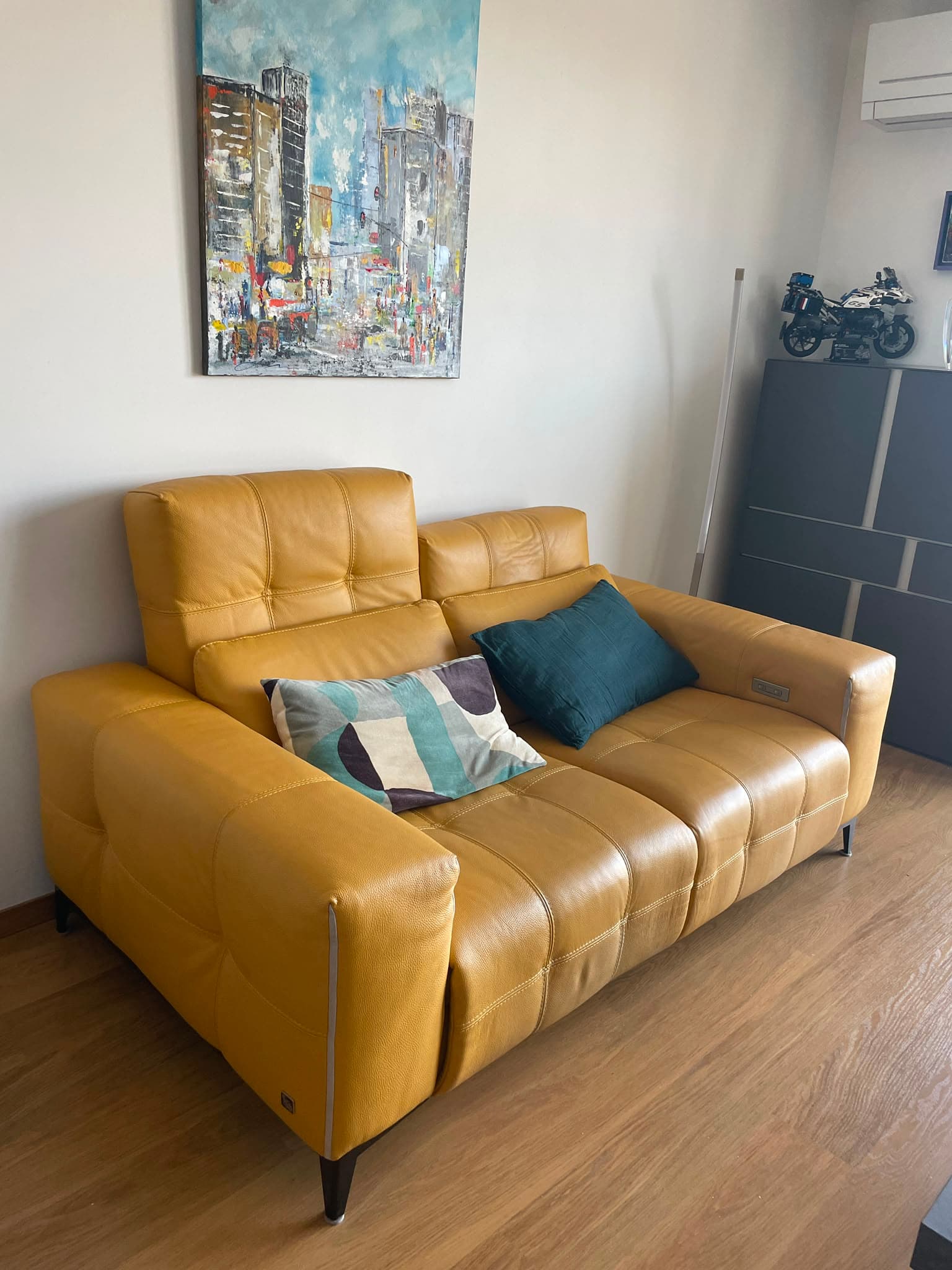 A modern two-seater reclining loveseat upholstered in mustard yellow leather, featuring deep tufting and integrated power recline mechanisms. — 3D model