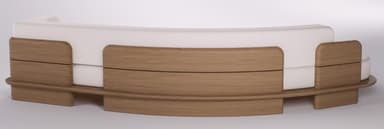 A contemporary curved sofa with white fabric upholstery and exposed light wood back panels and base. — 3D model