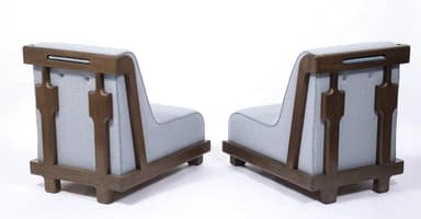 A contemporary low-profile, armless lounge chair featuring a light blue upholstered seat and backrest, elegantly framed by a dark brown wooden structure. The upholstery has a subtle textured pattern and light blue piping along its edges, contrasting with the smooth, rounded corners of the wooden frame. The chair rests on small, recessed wooden feet. — 3D model