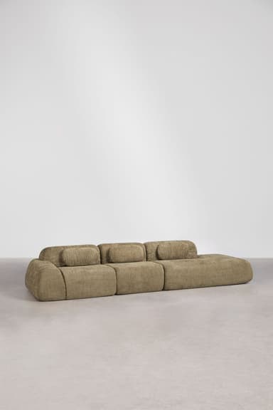 A long, low-profile modular sectional sofa composed of multiple units, upholstered in a textured khaki-colored fabric. The design features soft, rounded edges and cylindrical back cushions that rest atop the base units. The sofa appears to be in excellent, new condition, placed on a light-colored floor against a plain white wall. — 3D model
