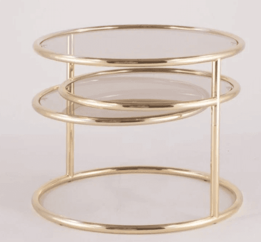 A round, tiered end table with a metallic frame and glass tops. The table features two circular shelves suspended by vertical supports, all constructed from a polished, gold-toned metal. The glass surfaces appear to be tinted or smoked. — 3D model