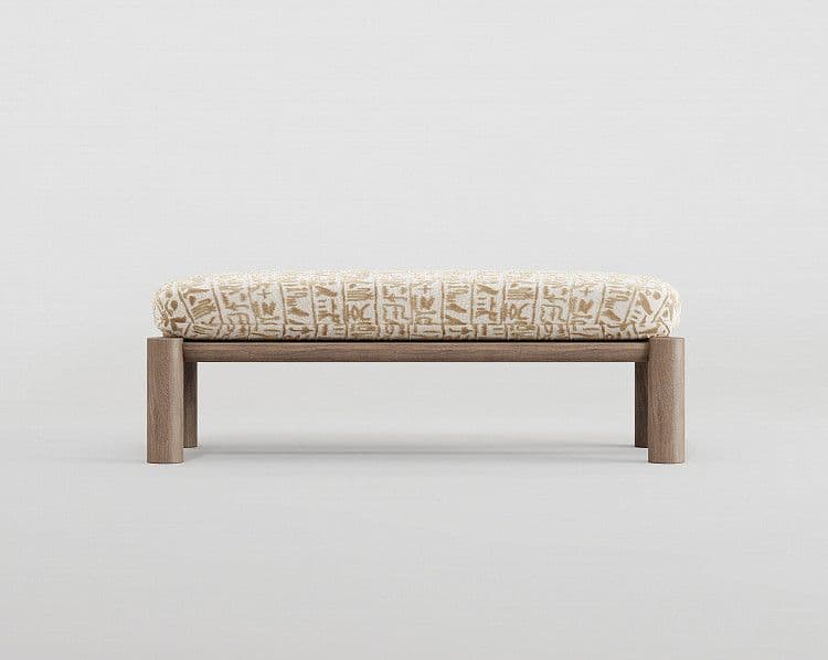 A bench with a rectangular wooden frame and a padded, upholstered seat. The upholstery features a pattern resembling ancient Egyptian hieroglyphs in a golden-brown hue against a cream background. The bench has four square legs that extend upwards to form part of the frame supporting the seat. — 3D model