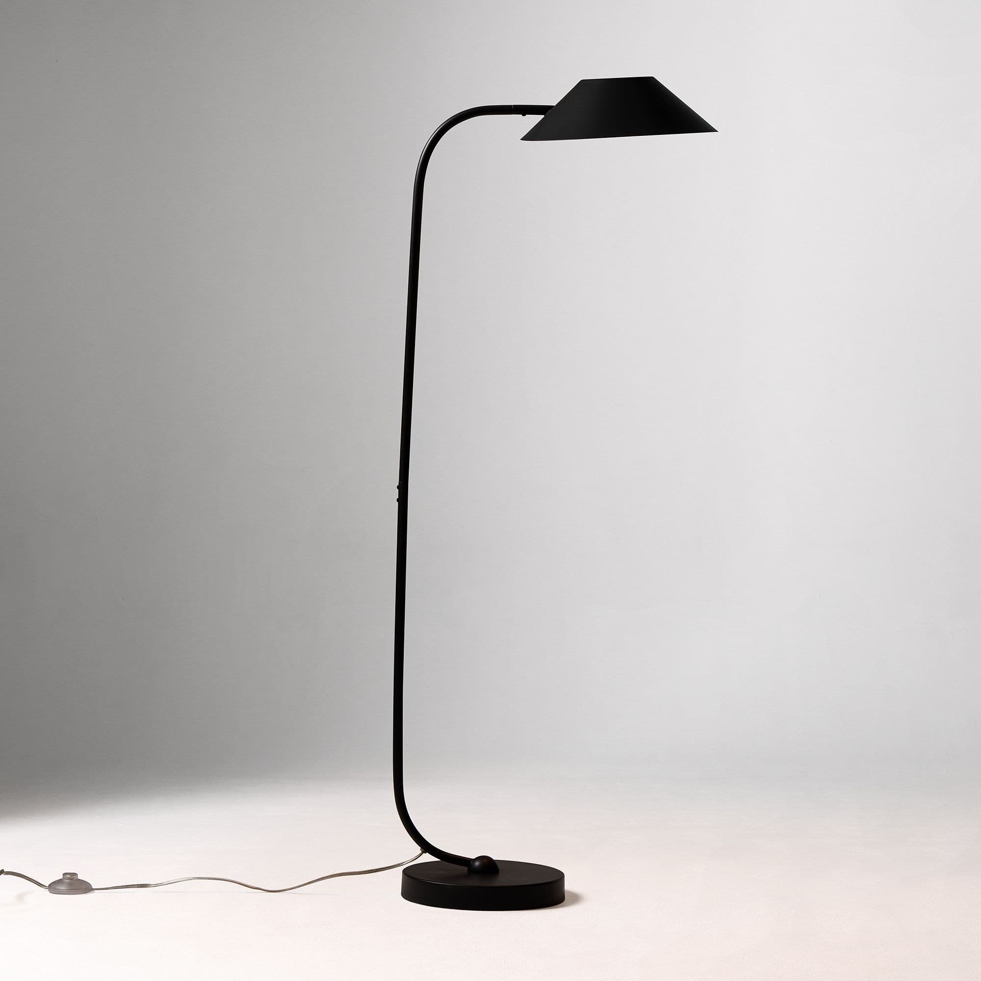 A tall, slender floor lamp with a matte black finish, a curved stem, a conical shade, and a round flat base. — 3D model
