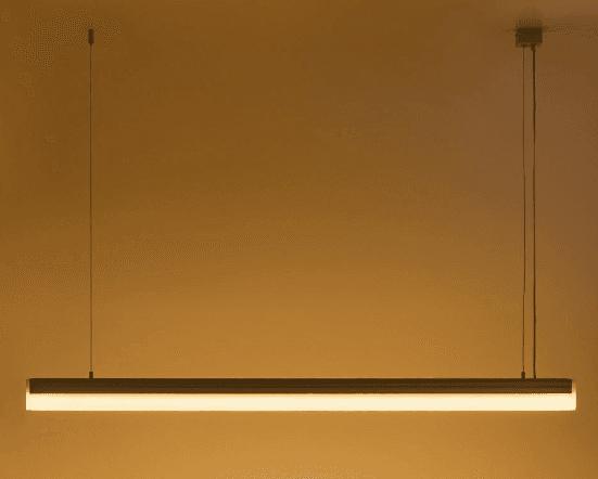 A modern, minimalist linear LED pendant light, suspended by two thin wires. It features a rectangular metallic housing, likely aluminum, with a translucent diffuser running along its length, indicating integrated LED illumination. — 3D model