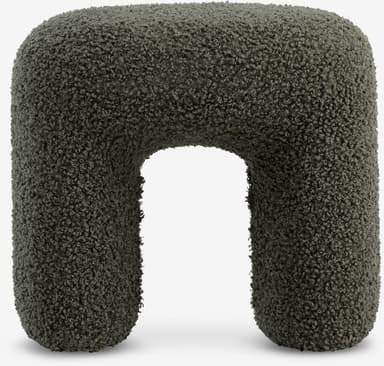 A contemporary U-shaped stool upholstered entirely in a dark green, textured boucle fabric. The design features soft, rounded edges and a monolithic form, creating a sculptural and inviting appearance. — 3D model