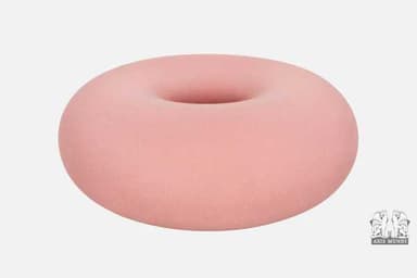 A circular ottoman with a matte finish, resembling a torus or a donut shape. It has a smooth, continuous surface with a central opening. The object appears to be designed for seating or as a footrest. — 3D model