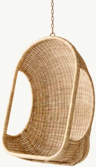 A natural wicker hanging egg chair featuring a classic rounded, cocoon-like shape suspended by a metal chain. The chair is entirely woven from natural wicker or rattan fibers, forming a sturdy yet visually lightweight shell for seating. Its organic texture and form are suitable for various interior and exterior relaxation spaces. — 3D model