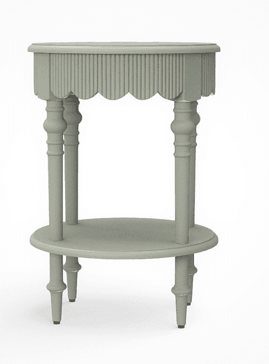 A light sage green, two-tiered accent table featuring a distinctive scalloped and reeded apron around the upper tabletop. The table is supported by four elegantly turned spindle legs, which also provide support for a circular lower shelf. The feet are simple and finished with small black glides. The overall design suggests a blend of traditional and cottage aesthetics. — 3D model