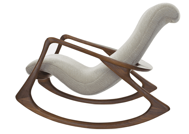 A modern rocking chair with a curved wooden frame and a padded upholstered seat and backrest. The frame features flowing lines and appears to be made from a dark wood, possibly walnut. The upholstery is a light-colored textured fabric. — 3D model