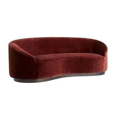 A curved sofa with a plush velvet upholstery in a deep reddish-brown hue. The sofa features a rounded silhouette with integrated armrests and a low-profile base. The base appears to be made of a darker material, possibly wood or metal, with a smooth finish and a slightly curved profile that mirrors the overall shape of the sofa. — 3D model