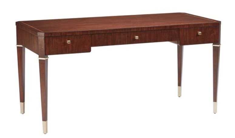 A sophisticated writing desk constructed from dark-stained wood, featuring a rectangular top with subtly rounded corners. The desk incorporates three drawers across its front, each adorned with a small, rectangular brass pull. It stands on four slender, tapered legs that are reinforced with brass bands at the top and capped with polished brass sabots at the feet, adding an elegant touch. — 3D model