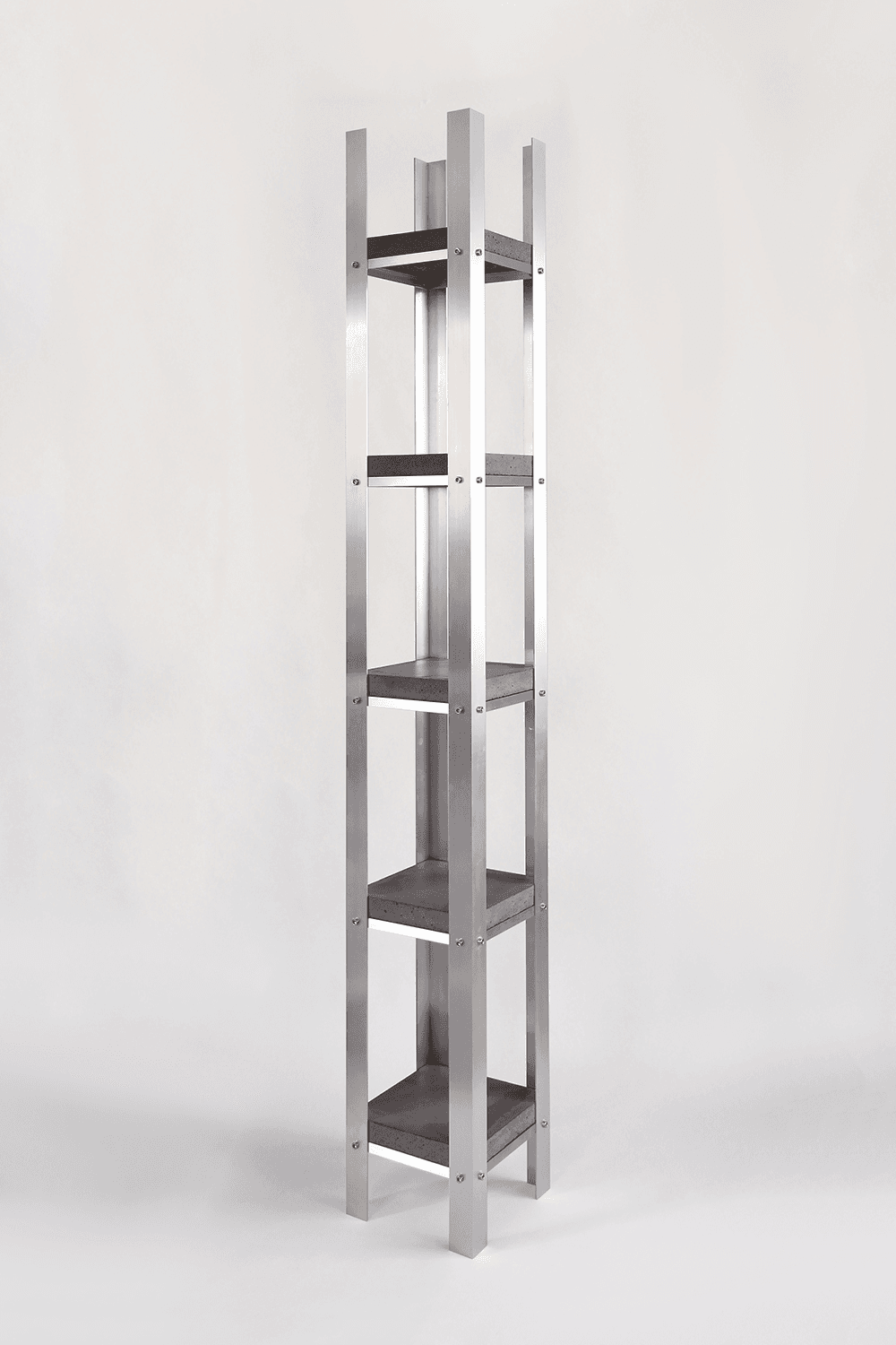 A tall, narrow shelving unit with a minimalist design. It features a frame constructed from four vertical aluminum posts connected by horizontal aluminum supports at intervals. Between these supports are four dark gray shelves, appearing to be made of concrete or a similar composite material. The shelves are attached to the frame with visible screws. — 3D model