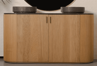 A modern double bathroom vanity featuring a cabinet with a fluted light wood finish and a dark, marble-patterned countertop with two integrated circular stone basins. The cabinet has rounded ends and two small gold-toned handles. — 3D model