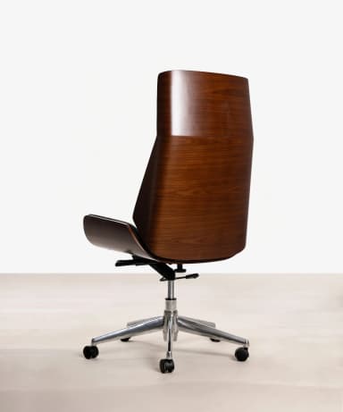 An armless office chair with a molded plywood shell finished in a dark wood veneer, supported by a polished aluminum five-star swivel base with casters. The chair features a high back and a subtly curved seat. — 3D model
