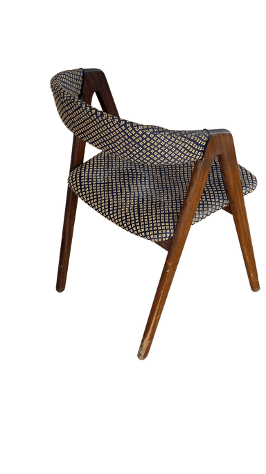 A wooden chair with upholstered seat and backrest. The upholstery features a repeating pattern of small, diamond-shaped motifs in a contrasting color. The frame appears to be made of wood with a dark finish. The chair has a simple, functional design. — 3D model